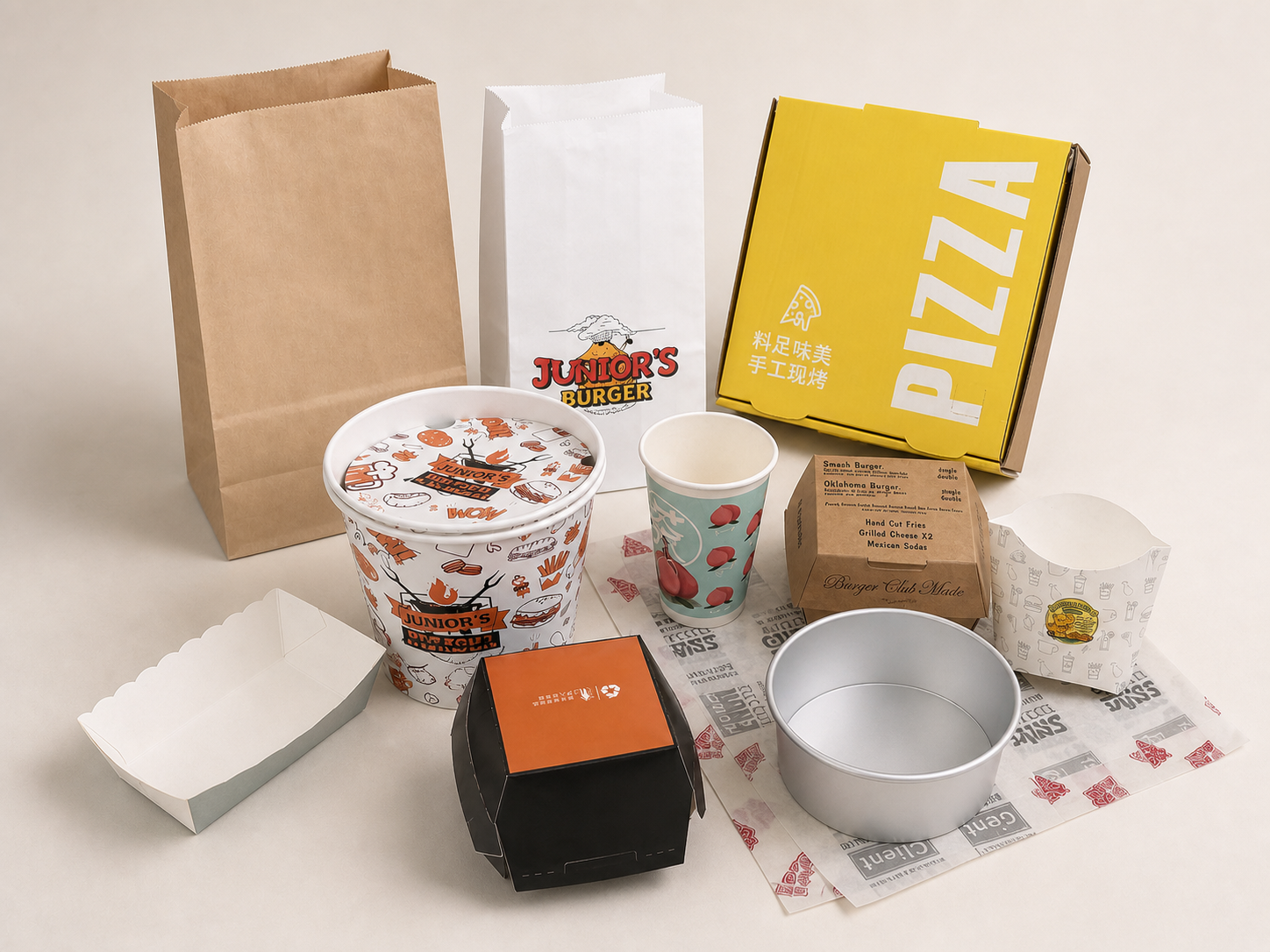 Paper bags, paper cups, food boxes and printed wrapping papers displayed together